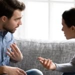 A couple having a heated argument on their couch