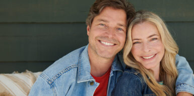 Man and woman over 50 smiling to camera as a couple