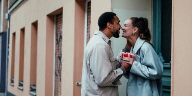 a couple kissing, looking into each others eyes