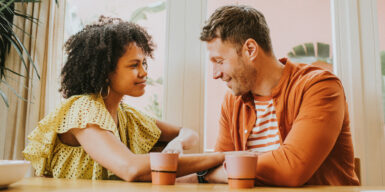 Man and woman look at each other and talk as a symbol for questions to ask